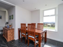 A dining room with a table and chairs at Tapps Lodge Brixton near Yealmpton, South Devon