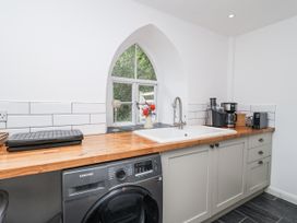 A kitchen with a sink and washer at Tapps Lodge in Brixton near Yealmpton, South Devon