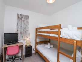 A bedroom with a bunk bed and desk at Tapps Lodge, Brixton near Yealmpton, South Devon
