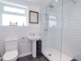 A bathroom with a shower and sink at Tapps Lodge in Brixton near Yealmpton, South Devon