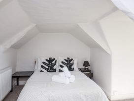 A bedroom with a bed and nightstand at Tapps Lodge Brixton near Yealmpton, South Devon