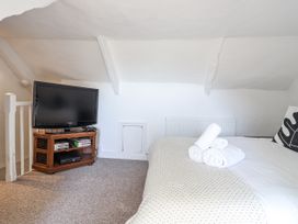 A bedroom with a bed and television at Tapps Lodge Brixton near Yealmpton, South Devon