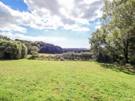 A garden with grass and trees at Tapps Lodge Brixton near Yealmpton, South Devon
