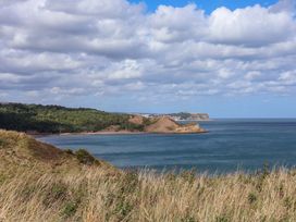 A coastal view with hills and water at Floraville