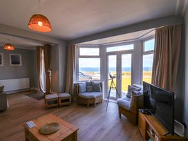 A living room with a sofa and television at Floraville