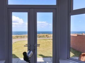 A view from a snug with a telescope overlooking the sea at Floraville