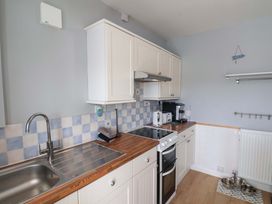 A kitchen with cabinets and appliances at Floraville