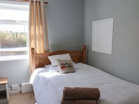 A bedroom with a bed and window at Floraville