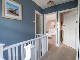 A hallway with stairs and doors leading to bedrooms at Floraville
