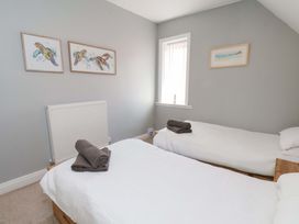 A bedroom with two beds and a radiator at Floraville