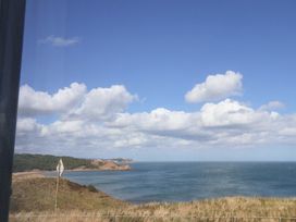 A view of the sea and hills under a cloudy sky at Floraville
