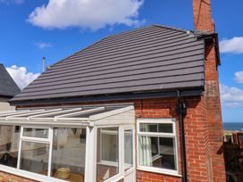 A house exterior with roof and conservatory at Floraville