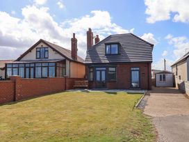 A house with a lawn and conservatory at Floraville in 