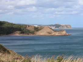 A view of hills and water with a town in the distance at Floraville
