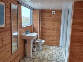 A bathroom with a sink, toilet, and shower at Floraville in Cayton Bay