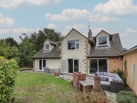A house with patio furniture and garden area at Harran in Pershore
