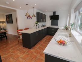 A kitchen with cabinets and a sink at Harran in Pershore