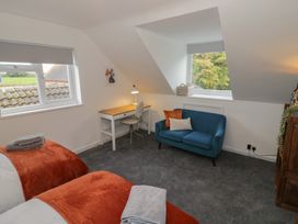 A bedroom with a bed and a desk at Harran in Pershore