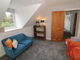A bedroom with a sofa and shelf at Harran in Pershore