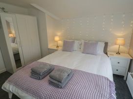 A bedroom with a bed and wardrobe at Harran in Pershore
