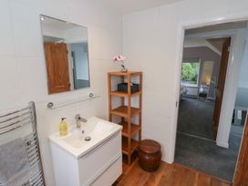 A bathroom with a sink and shelf at Harran in Pershore