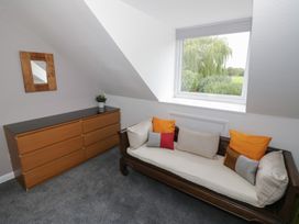 A bedroom with a sofa and dresser at Harran in Pershore