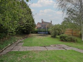 A garden with a trampoline and trees at Harran in Pershore