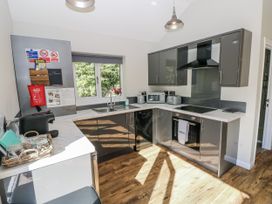 A kitchen with appliances and utensils at Dwrgi in Llanybydder