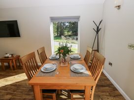 A dining room with a table set for a meal at Dwrgi in Llanybydder
