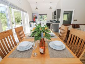 A dining room with a table set for a meal at Dwrgi in Llanybydder
