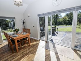 A dining area with a table and chairs at Dwrgi in Llanybydder