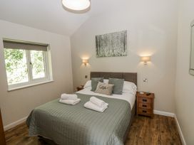 A bedroom with a bed and bedside table at Dwrgi in Llanybydder