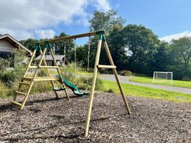 A swingset with swings and slide at Dwrgi Aber near Llanybydder