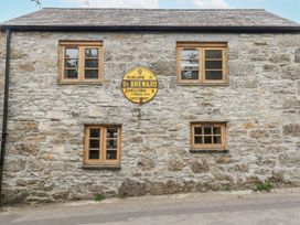 A stone wall with windows and a sign at The Old Dairy in 
