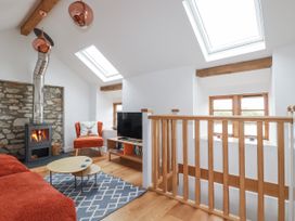 A living room with a sofa and fireplace at The Old Dairy in 