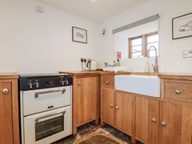 A kitchen with an oven, sink, and cabinets at The Old Dairy 