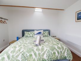 A bedroom with a bed and bedside table at The Old Dairy