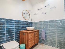 A bathroom with a sink and vanity unit at The Old Dairy