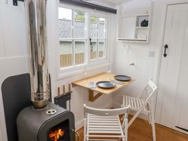 A dining area with a table and chairs at Shepherd's Hut in Perranarworthal