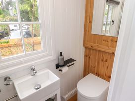 A bathroom with sink and toilet at Shepherd's Hut in Perranarworthal