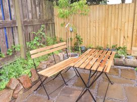 A table and chairs in a garden at Shepherd's Hut Perranarworthal