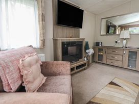 A living room with a sofa and television at Delta Superior