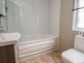A bathroom with bathtub, sink, and toilet at Delta Superior