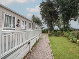 A mobile home with a pathway and lawn at Delta Superior