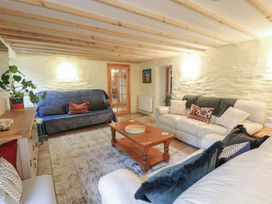 A living room with seating arrangements at Penally Mews in St Dogmaels