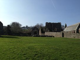 Ruins with grass and trees at Penally Mews in St Dogmaels