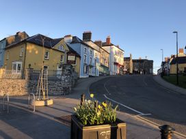 A street view with buildings and flower planter at Penally Mews St Dogmaels