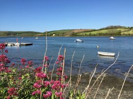 A view of the water with boats and flowers at Penally Mews in St Dogmaels