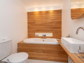A bathroom with a bathtub and sink at The Old Vicarage in St Issey
