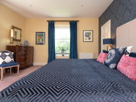 A bedroom with a bed and a chest of drawers at The Old Vicarage St Issey